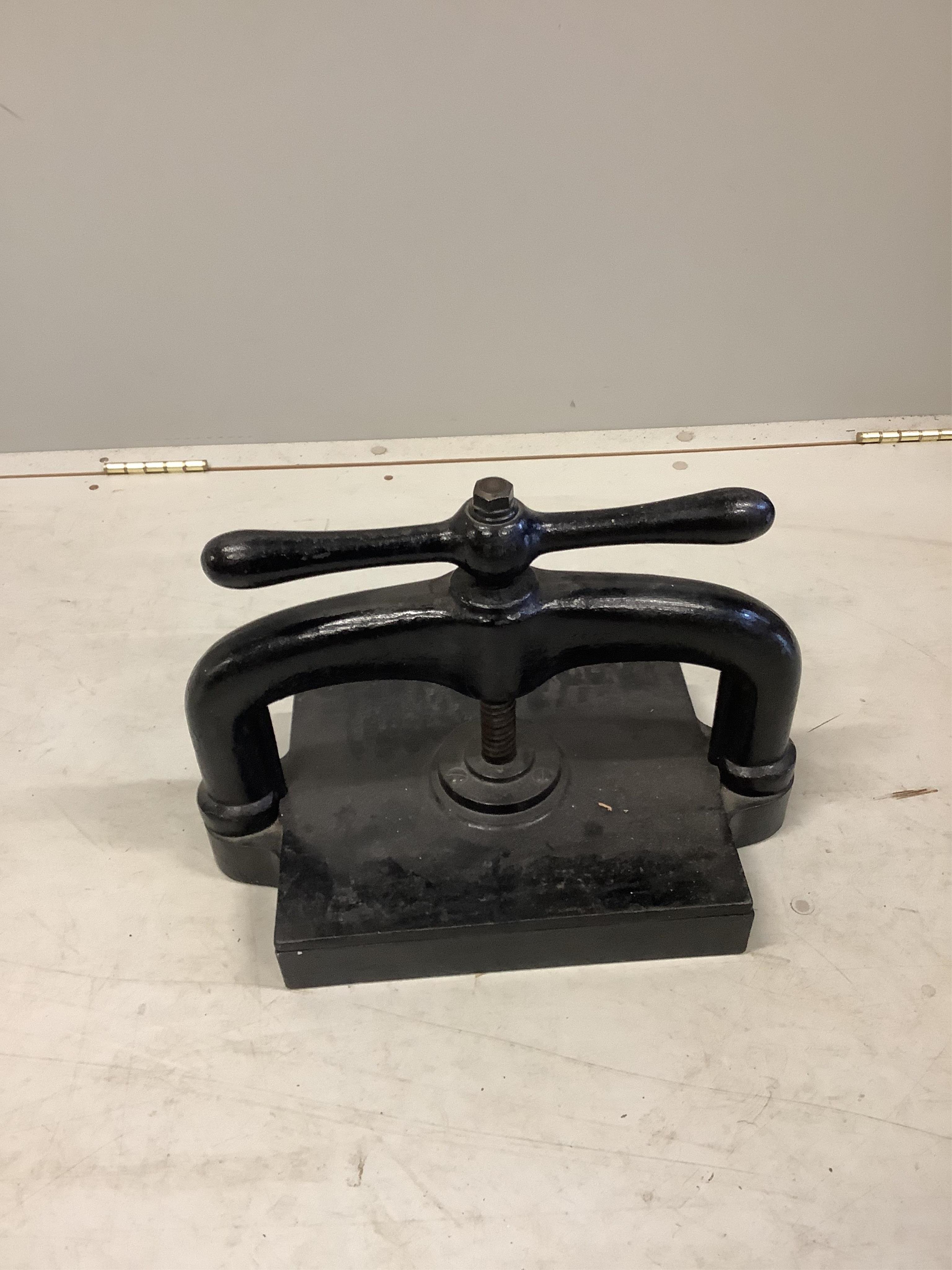 A Victorian cast iron book press, width 42cm, depth 25cm, height 32cm. Condition - fair